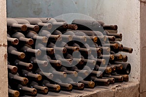 Old bottles of wine stacked in rows