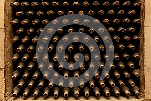 Old bottles of wine stacked in rows