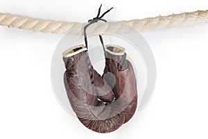 Old boxing gloves hanging on the boxing ring rope