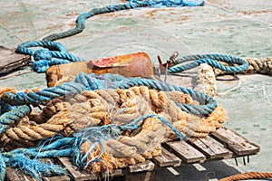 Old braided jute ropes with rusty fire extinguishers