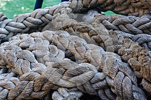 Old braided rope on the wooden deck of a sea boat, anchor mechanisms