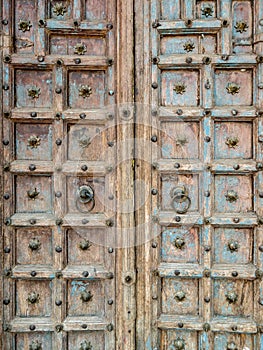 The old brass door knob on the large wooden gate in the Chinese style