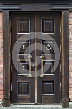 Old brass handle on vintage wood door