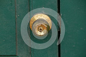 Old brass knobs on the green door