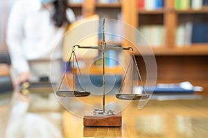 Old Brass Law Scale vintage style is laid on wood glass table in Lawyer office meeting room