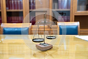 Old Brass Law Scale vintage style is laid on wood glass table in Lawyer office meeting room