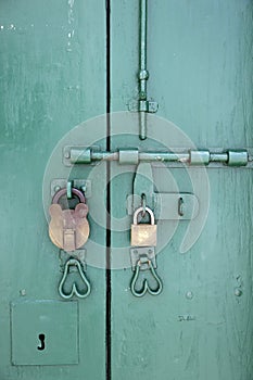 Old Brass Padlock on Wooden Green door