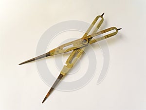 Old brass reduction compass or proportional scale divider. Geometry tool used to scale designs