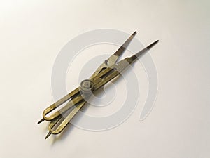 Old brass reduction compass or proportional scale divider. Geometry tool used to scale designs