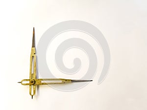 Old brass reduction compass or proportional scale divider. Geometry tool used to scale designs