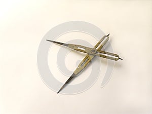 Old brass reduction compass or proportional scale divider. Geometry tool used to scale designs