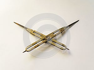 Old brass reduction compass or proportional scale divider. Geometry tool used to scale designs