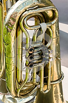 Old brass tuba mechanism. worn valves bass tuba.