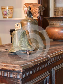 Old brazen bells over wooden table
