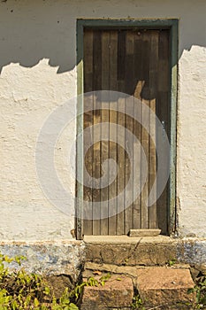 Old brazilian farm house with wooden door and stone steps