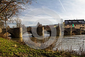 Old brick arch bridge over Tauber river in Tauberrettersheim, Germany