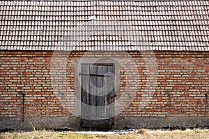 Old brick barn with wooden doors