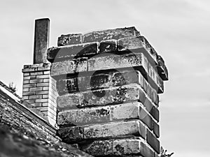 Old brick brick chimney on the house roof