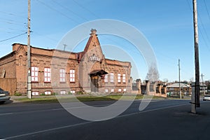 The old brick building of the city hospital 1898 against the backdrop of the city of Yeniseysk. Krasnoyarsk region. Russia