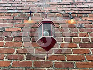 Old brick building facade holiday lights vintage lamp looking up