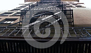 Old brick building fire escape with forged iron railings. Vancouver, BC, Canada