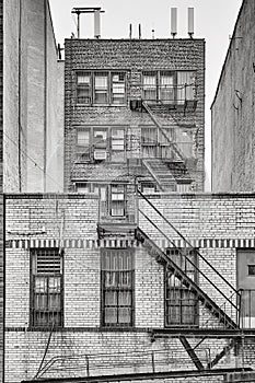 Old brick building with fire escapes, New York City.