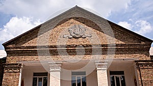 Old brick building with the symbols of the Soviet Union