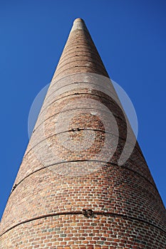 An old brick chimney at the beach in Malaga, Spain photo