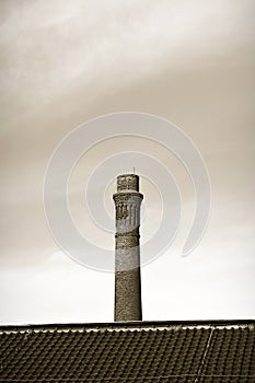 Old brick chimney isolated on sky - sepia toned