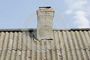 Old brick chimney on the roof of the house