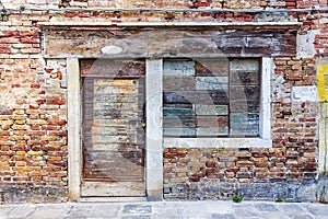 Old brick facade with boarded up windows