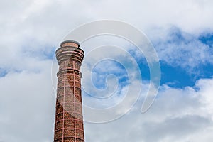 Old brick flue pipe in front of sky