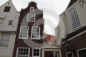 old brick houses and church at a beguinage (Begijnhof) - amsterdam - netherlands