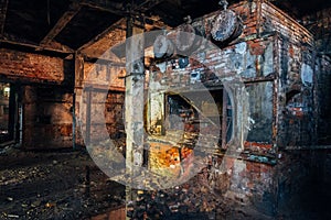 Old brick industrial stove in abandoned boiler room in factory