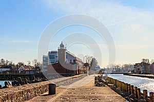 Old brick lighthouse at the Wieprza river mouth to the Baltic Sea in Darlowko, Poland