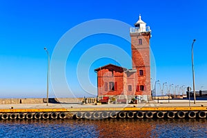 Old brick lighthouse at the Wieprza river mouth to the Baltic Sea in Darlowko, Poland