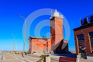 Old brick lighthouse at the Wieprza river mouth to the Baltic Sea in Darlowko, Poland