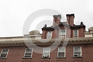 Old brick residential apartment building with roofline moulding details