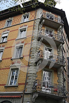 Old brick residential building with windows and balconies.