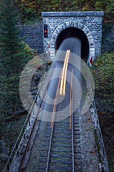 Old brick tunnel in the mountains and incoming train