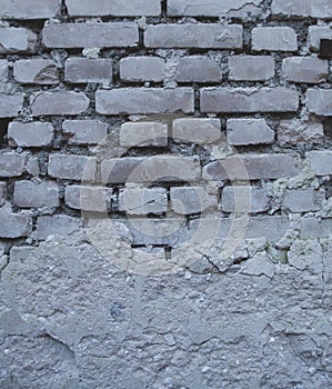 Old brick wall of an abandoned house background texture