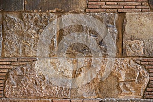 Old brick wall background. Ancient brickwork combined with big stone blocks and rocks.