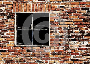 old brick wall with a broken window