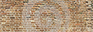 Old brick wall in brown color, panoramic background, antique grungy texture, blank background with space for text.