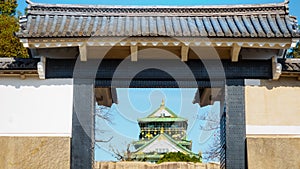 Old brick wall and ceramic roof from osaka castle with blue sky