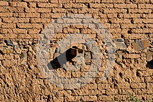 Old brick wall with clay drain pipe