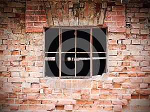 Old brick wall construction with broken windows