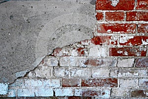 Old brick wall half coverd with cracked plaster, copyspace