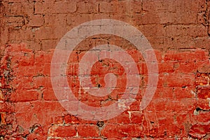 Old brick wall half painted in deep red, half in brown. Abstract background old red-brown brick wall