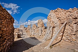 Old brick wall of historical city propped up by wooden props